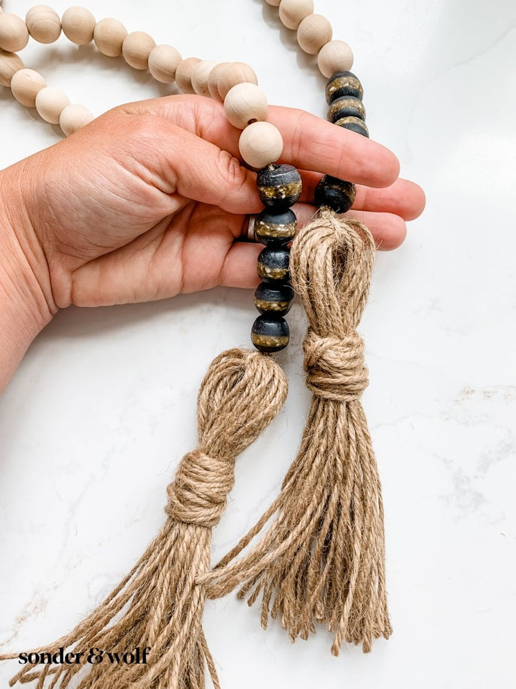 
                  
                    4ft Wood Bead Garland with 10 Black Kente Krobo Beads - sonder and wolf
                  
                