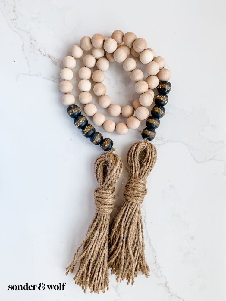 
                  
                    4ft Wood Bead Garland with 10 Black Kente Krobo Beads - sonder and wolf
                  
                