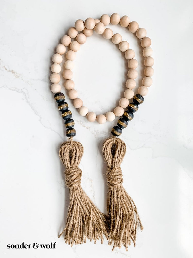 
                  
                    4ft Wood Bead Garland with 10 Black Kente Krobo Beads - sonder and wolf
                  
                
