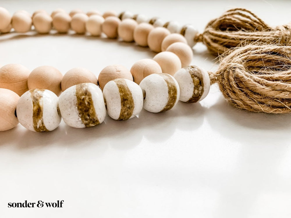 
                  
                    4ft Wood Bead Garland with 10 White Kente Krobo Beads - sonder and wolf
                  
                