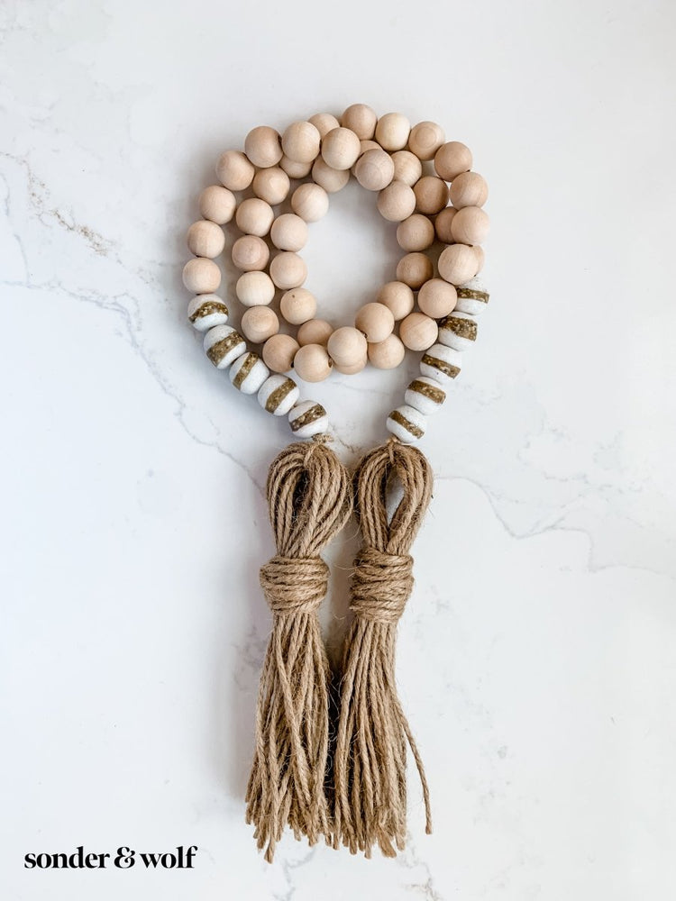 
                  
                    4ft Wood Bead Garland with 10 White Kente Krobo Beads - sonder and wolf
                  
                