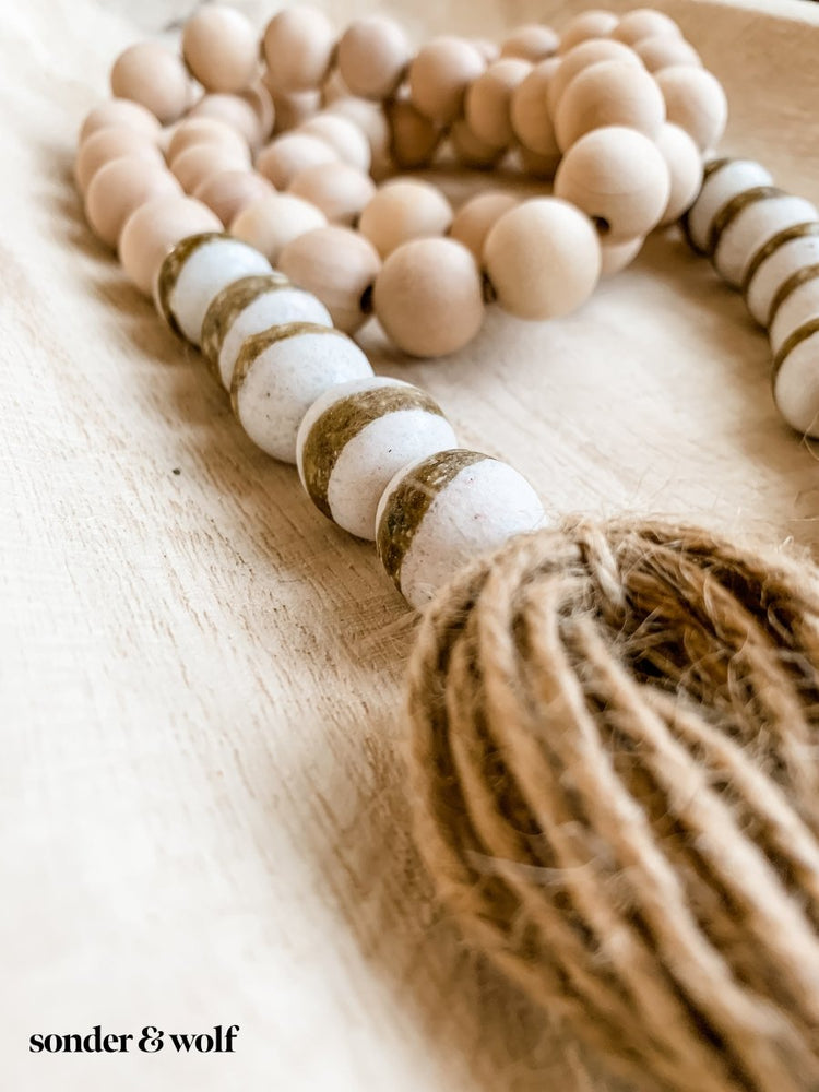 
                  
                    4ft Wood Bead Garland with 10 White Kente Krobo Beads - sonder and wolf
                  
                