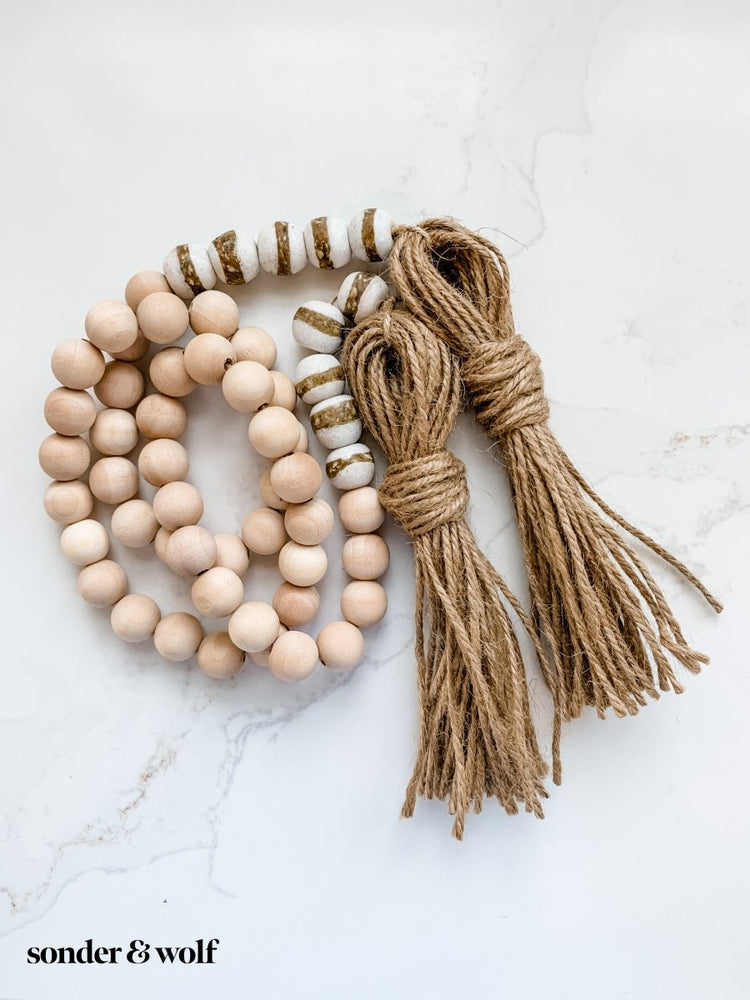 
                  
                    4ft Wood Bead Garland with 10 White Kente Krobo Beads - sonder and wolf
                  
                