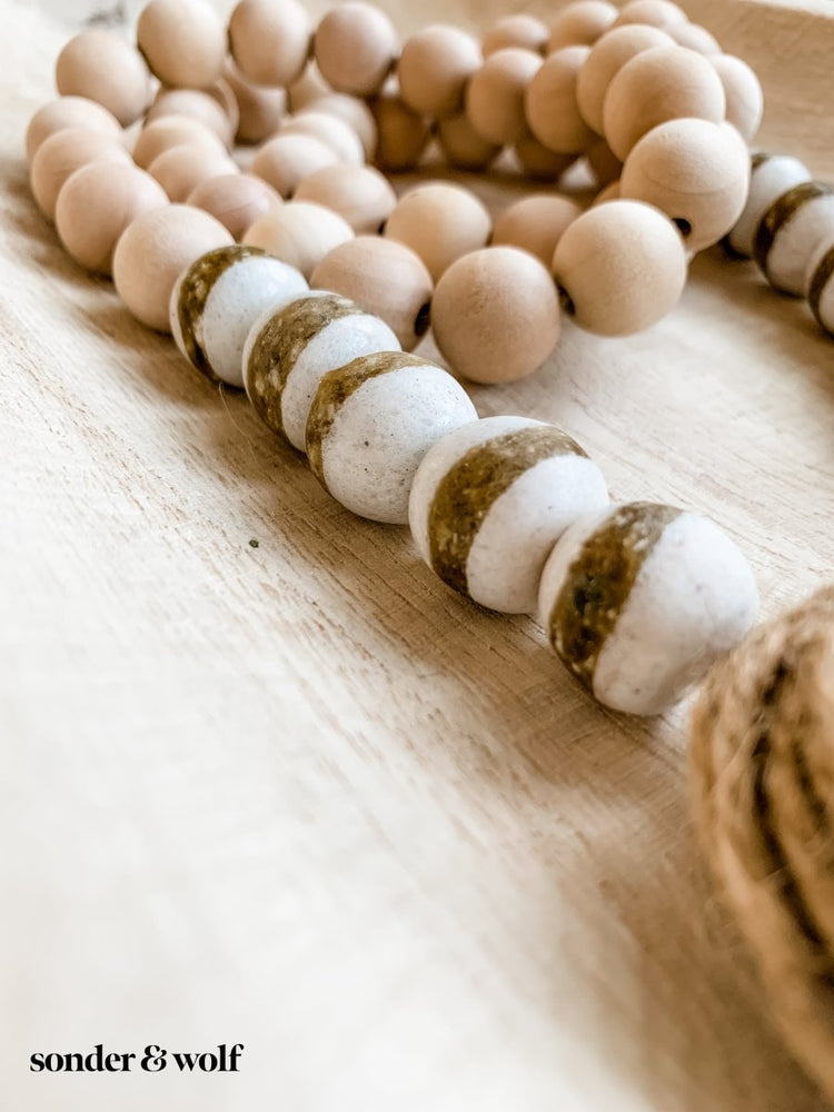 
                  
                    4ft Wood Bead Garland with 10 White Kente Krobo Beads - sonder and wolf
                  
                
