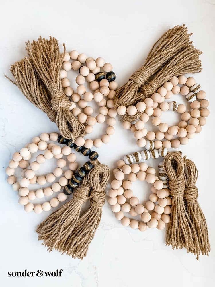 
                  
                    4ft Wood Bead Garland with 4 Black Kente Krobo Beads - sonder and wolf
                  
                