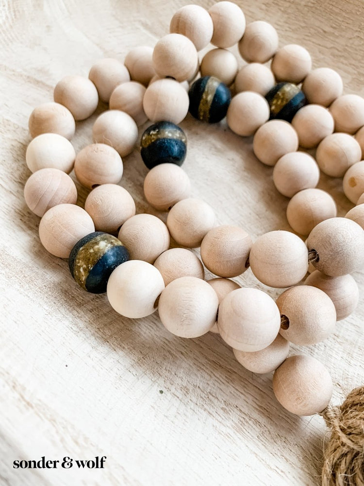 
                  
                    4ft Wood Bead Garland with 4 Black Kente Krobo Beads - sonder and wolf
                  
                