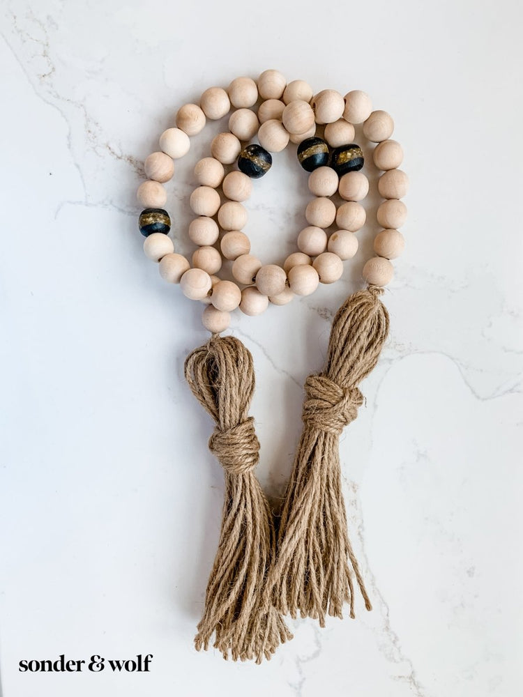 
                  
                    4ft Wood Bead Garland with 4 Black Kente Krobo Beads - sonder and wolf
                  
                