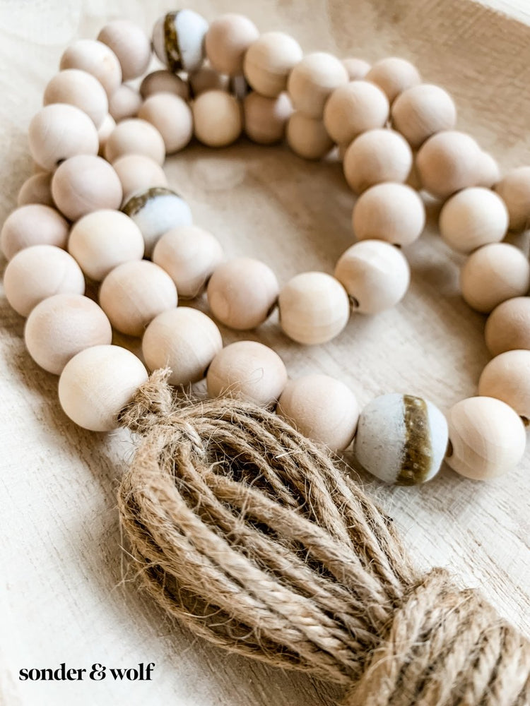 
                  
                    4ft Wood Bead Garland with 4 White Kente Krobo Beads - sonder and wolf
                  
                
