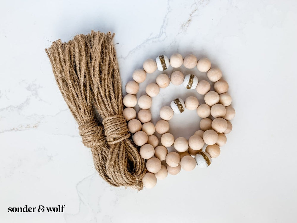 
                  
                    4ft Wood Bead Garland with 4 White Kente Krobo Beads - sonder and wolf
                  
                