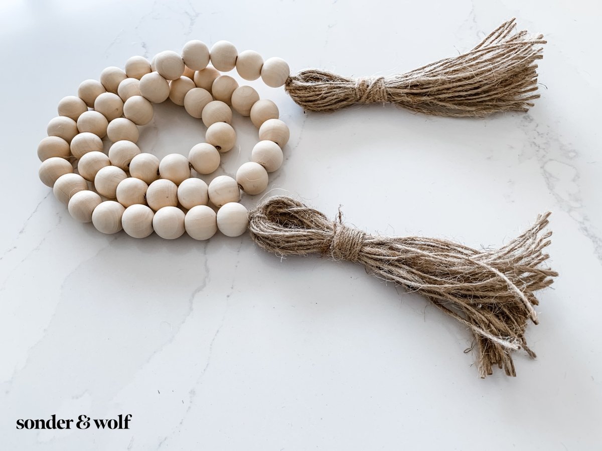 Load image into Gallery viewer, Wood Bead Garland with Jute Tassels - sonder and wolf
