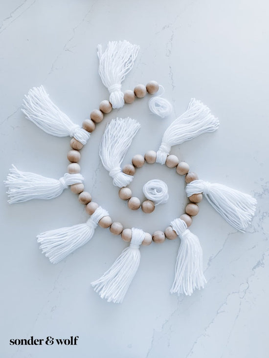 Load image into Gallery viewer, Wood Bead Garland with Yarn Tassels - sonder and wolf
